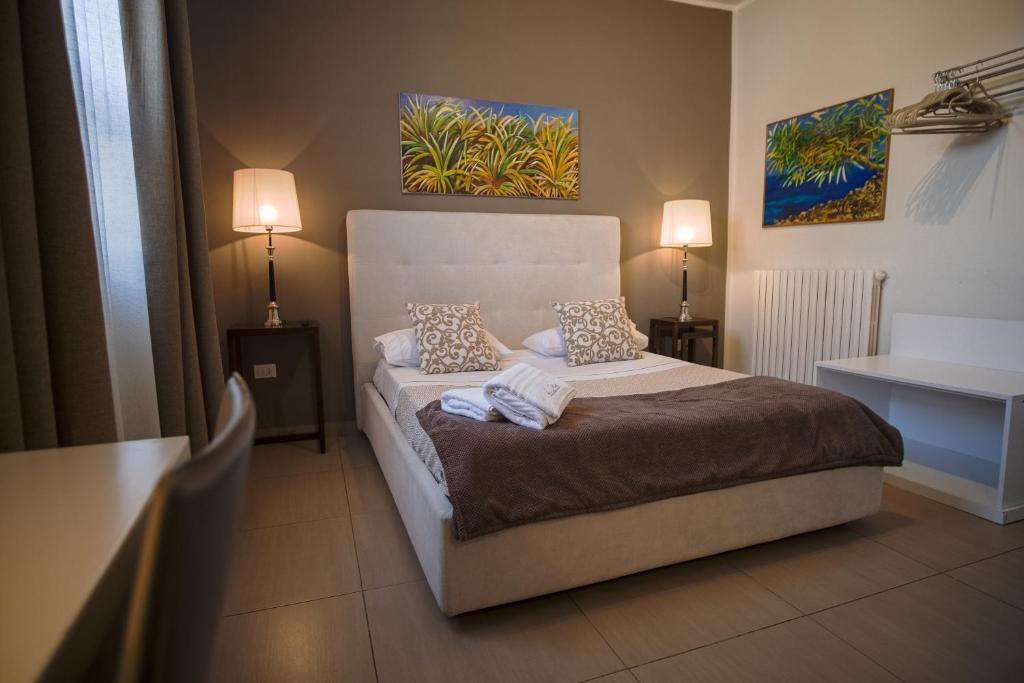 a bedroom with a bed with two pillows on it at B&B Le Muse in Mondello