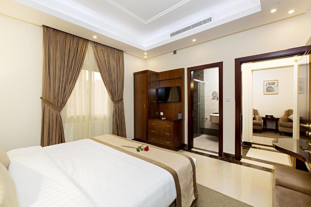 Postel nebo postele na pokoji v ubytování Sun Park Hotel Suites