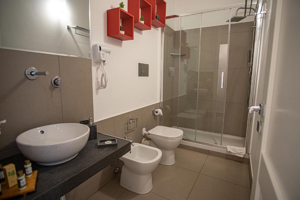 a bathroom with a sink and a toilet and a shower at B&B Le Muse in Mondello
