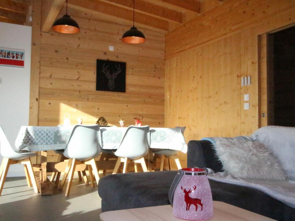 a dining room with a table and chairs in a room at Chalet Chamrousse, 5 pièces, 12 personnes - FR-1-340-211 in Chamrousse