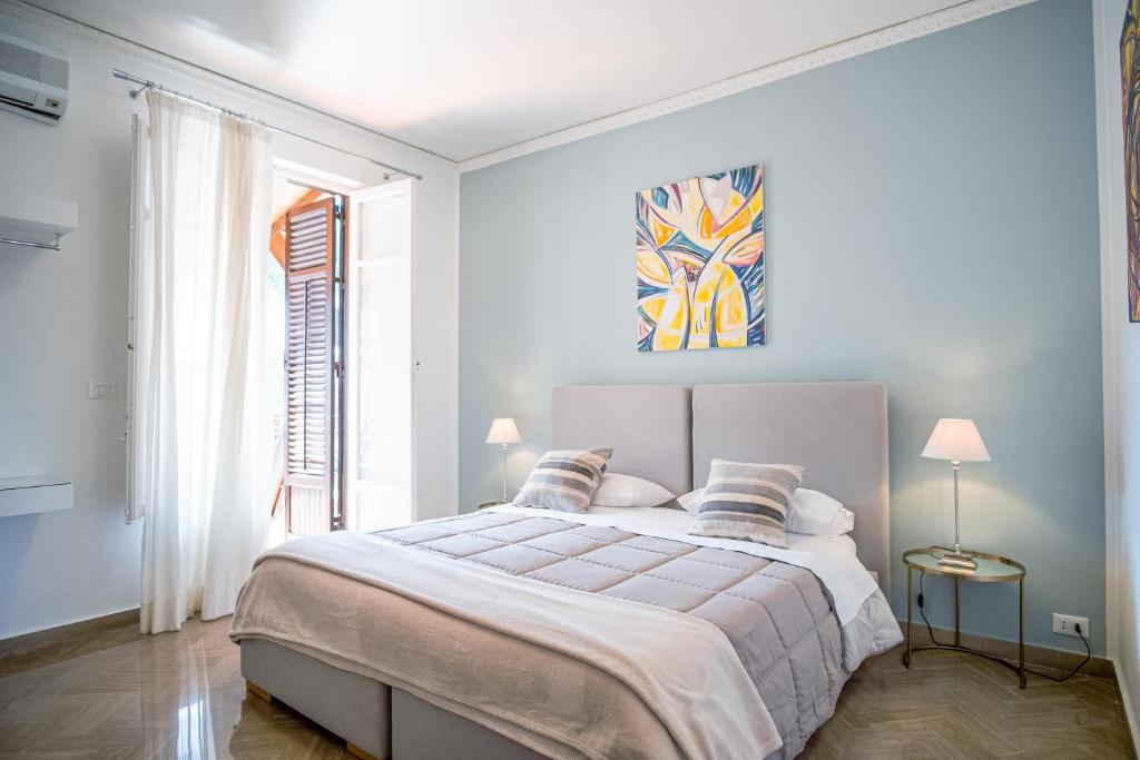 a white bedroom with a large bed and a window at B&B Le Muse in Mondello
