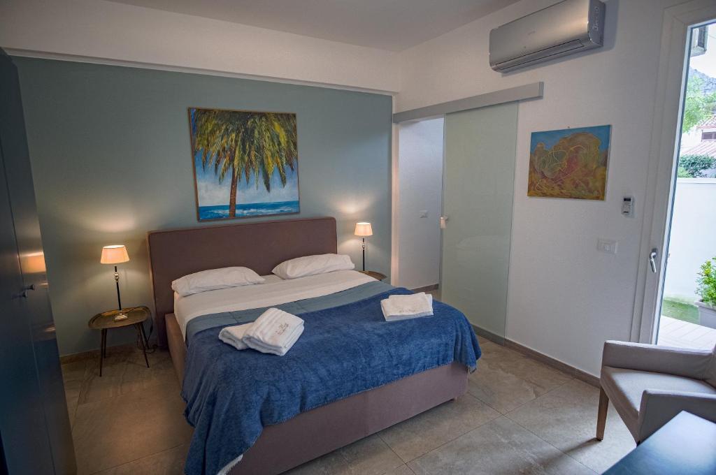 a bedroom with a bed with two towels on it at B&B Le Muse in Mondello