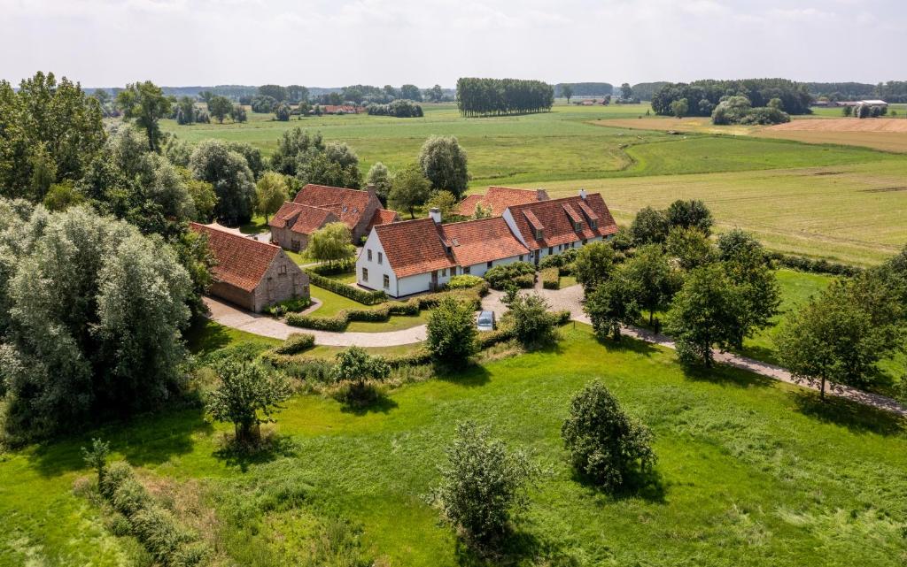 an aerial view of a house in a field at Loweide Lodges & Holiday Homes near Bruges in Oostkamp