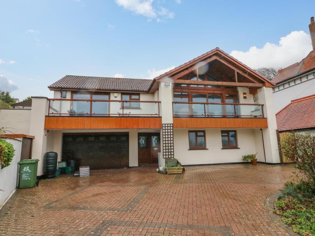 an exterior view of a house with a brick driveway at Shangri-La in Bideford