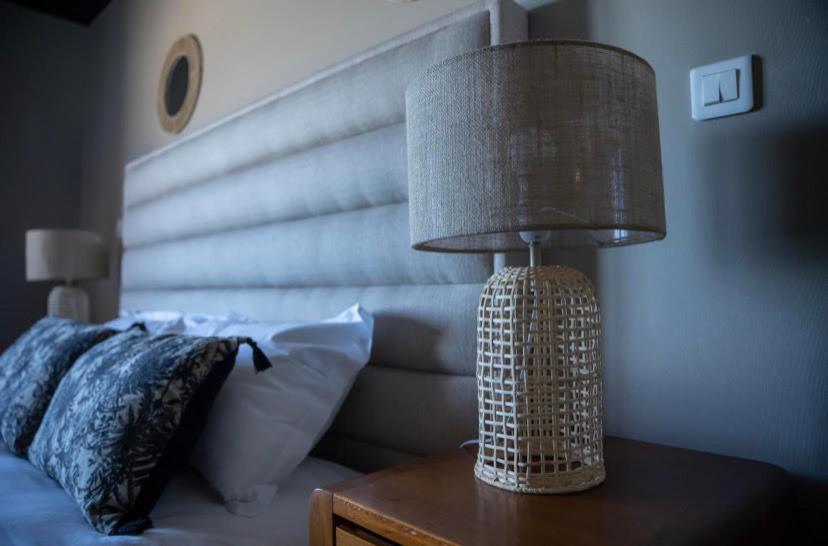a lamp sitting on a table next to a bed at Palm Beach in Ajaccio