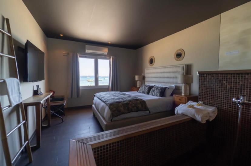a bedroom with a bed and a desk and a television at Palm Beach in Ajaccio