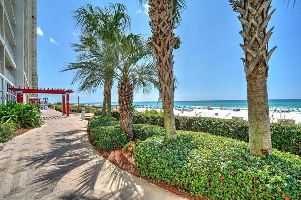 a pathway with palm trees and the beach at Majestic Beach Resort Tower 2 by Panhandle Getaways in Panama City Beach
