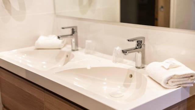 a bathroom with a white sink and a mirror at Palm Beach in Ajaccio
