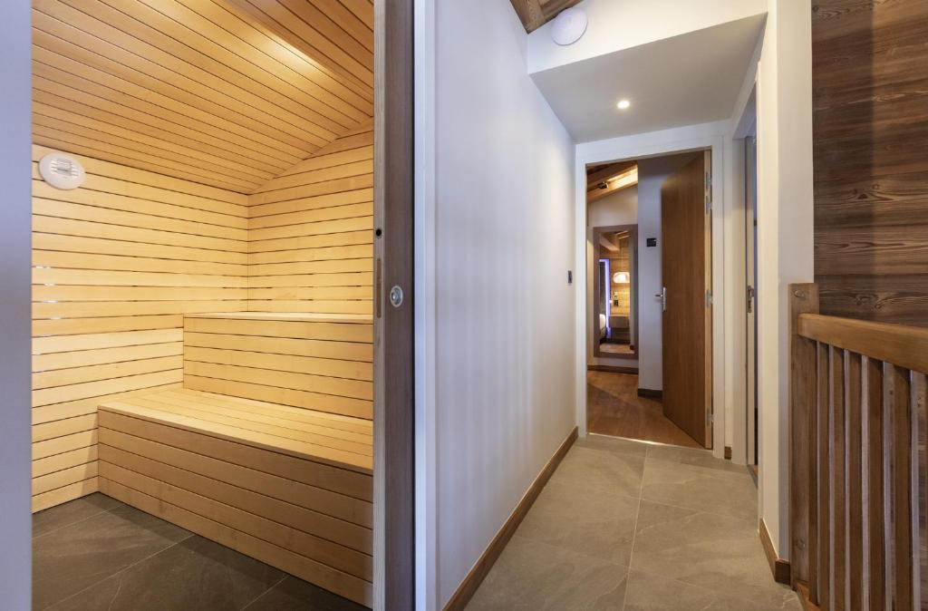 a sauna with wood paneling and a hallway at Les Balcons Platinium Val Cenis in Lanslevillard