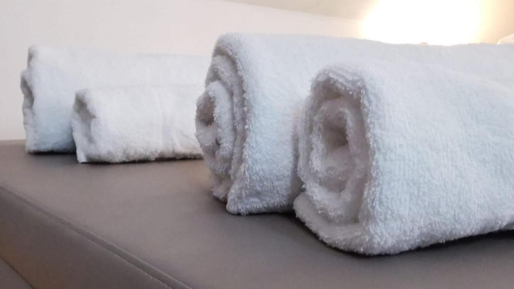 two towels are covered in snow on a bed at LE DUPLEX - Hyper centre - Gare - Wifi - Netflix - Disney + in Annecy