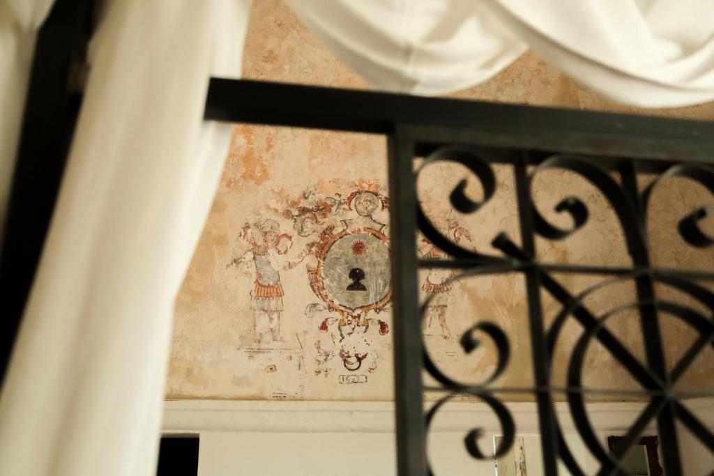 a window view of a painting on a wall at Masseria Francescani in Torre Chianca