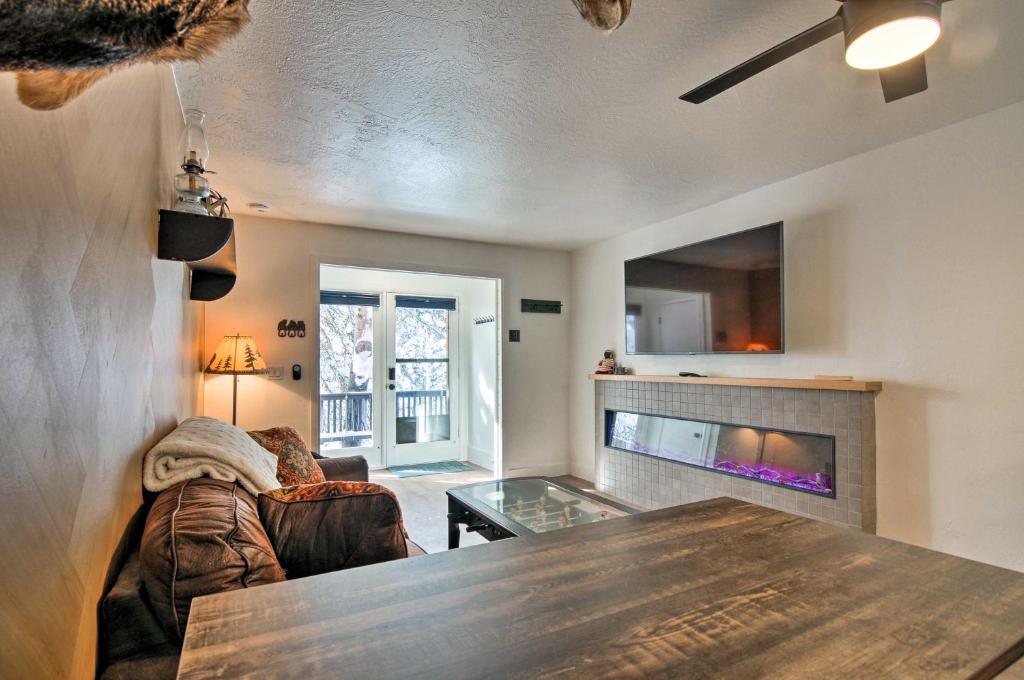 a living room with a table and a fireplace at The Cottages Ski-InandSki-Out Condo at Eagle Point! in Beaver
