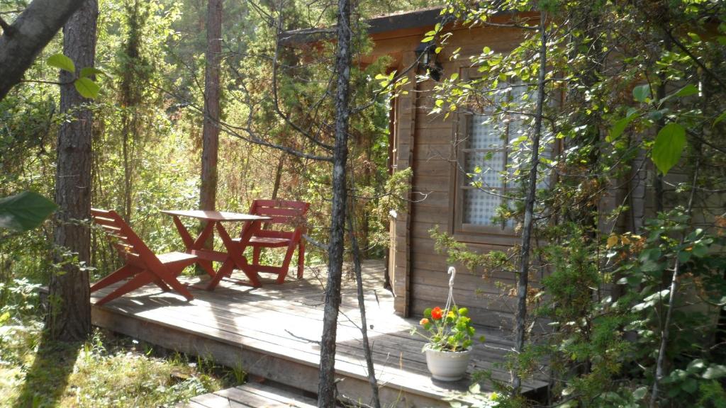 cabina con mesa y sillas en la cubierta en Paatsalu Camping, en Paatsalu