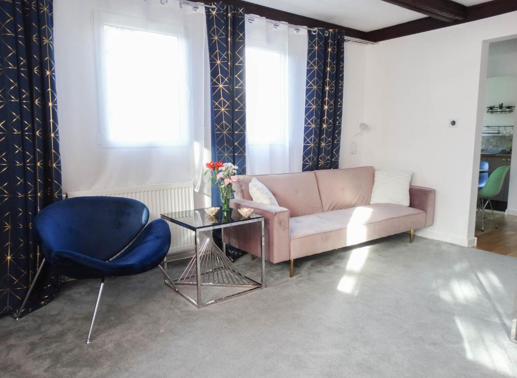 a living room with a couch and a table and a chair at SleepStation Karkonosze in Karpacz