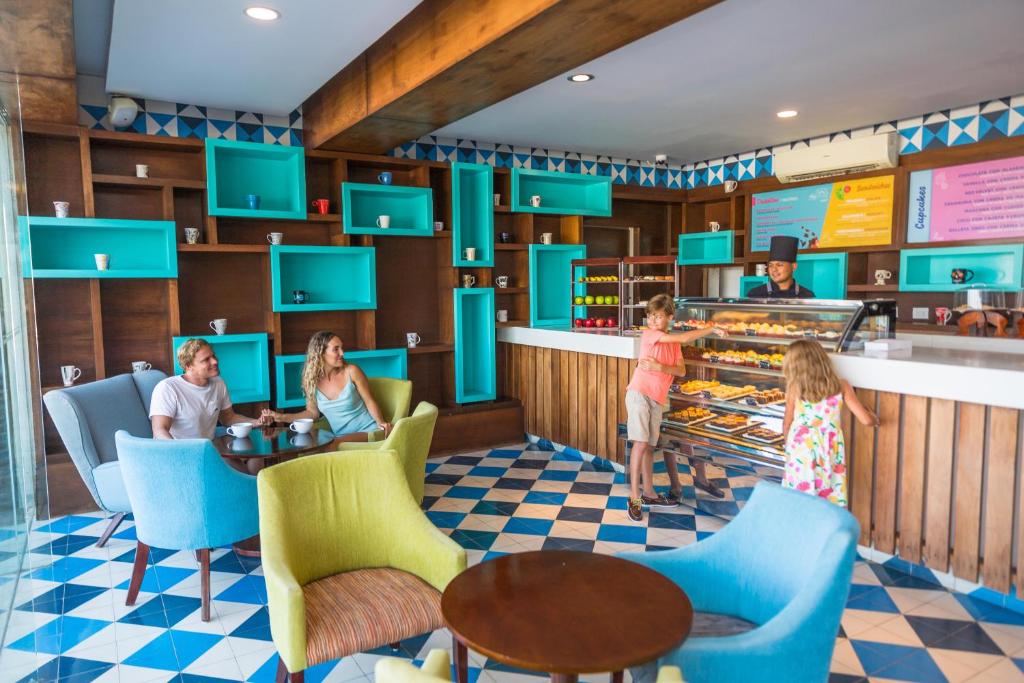 Children's play area with bakery counter, colorful shelving, seating area, wooden accents.