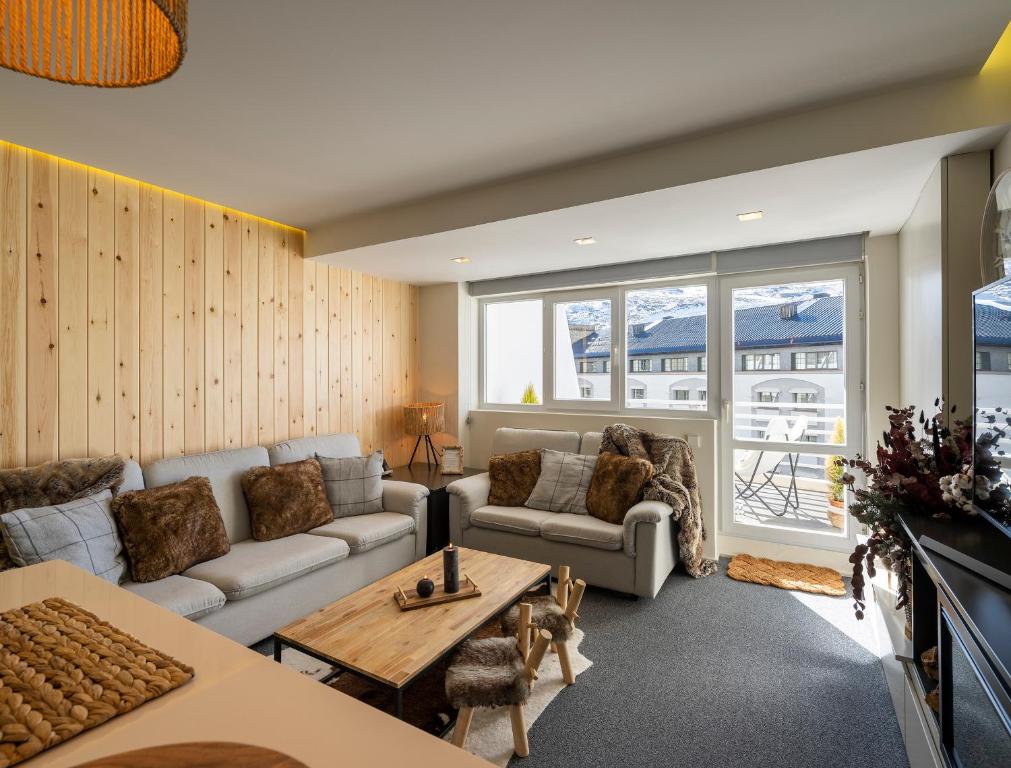 un soggiorno con divano e tavolo di Snow Home Apartment a Sierra Nevada
