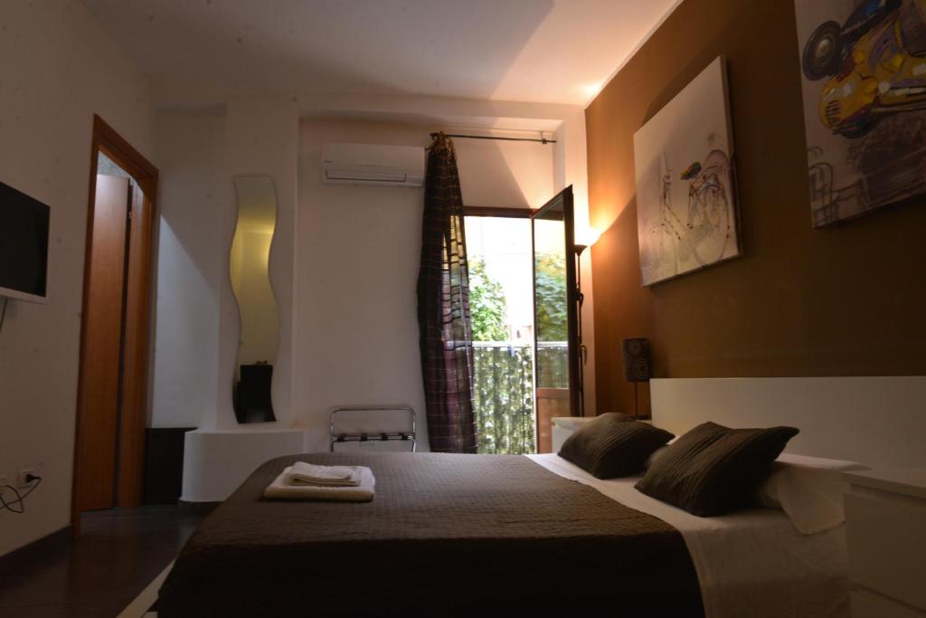 Säng eller sängar i ett rum på Globetrotter Catania Palace