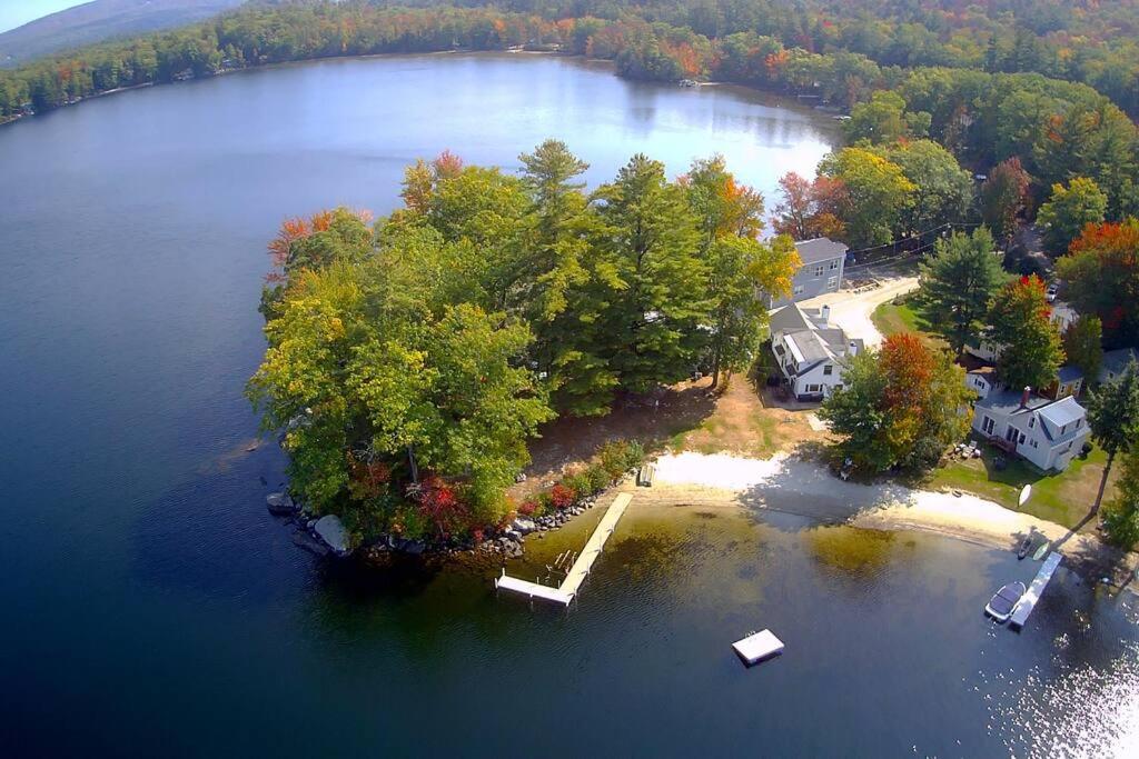 an aerial view of an island in a lake at Ski by day...Stargaze at the lake by night in Sunapee