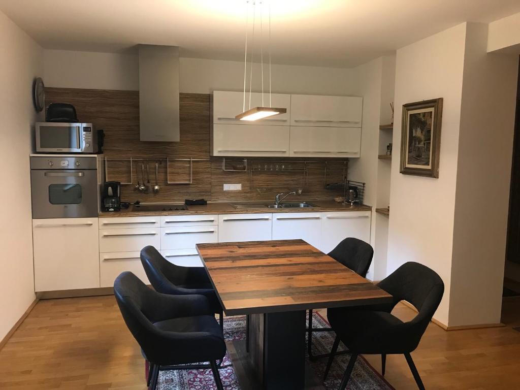 cocina con mesa de madera y algunas sillas en Enzian 14 - Schmuckstück von Bad Kleinkirchheim en Bad Kleinkirchheim