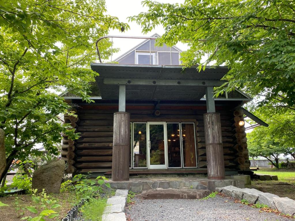a log cabin with a balcony on top of it at BAY MARINA Loghouse - Vacation STAY 09656v in Sakaide