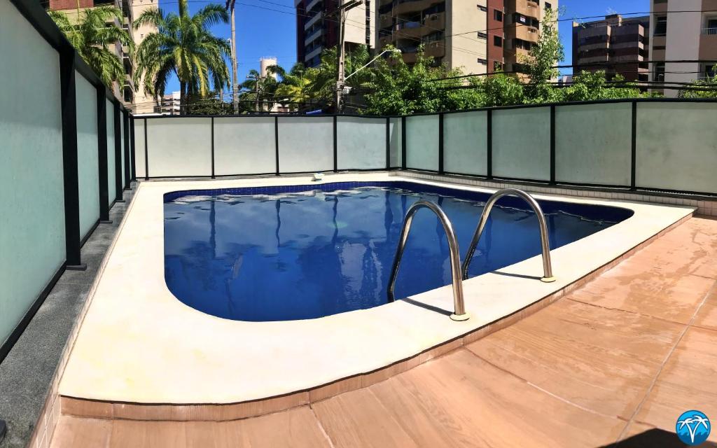 a swimming pool in the middle of a building at Vacanze - Golden Place in Maceió