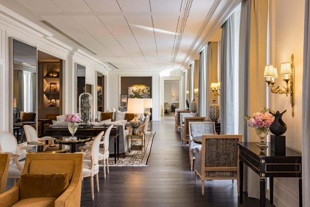 a lobby of a hotel with tables and chairs at InterContinental Paris Le Grand by IHG in Paris
