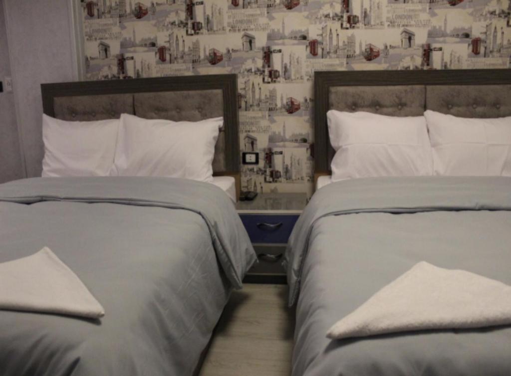 two beds sitting next to each other in a bedroom at Hostel Sunset Down town in Cairo