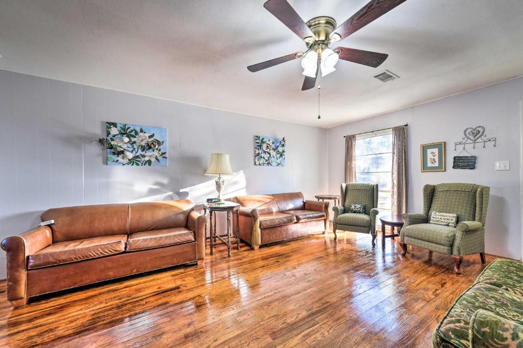 a living room with leather furniture and a ceiling fan at 10 Mi to Temple Lake Park Pet-Friendly Home in Temple