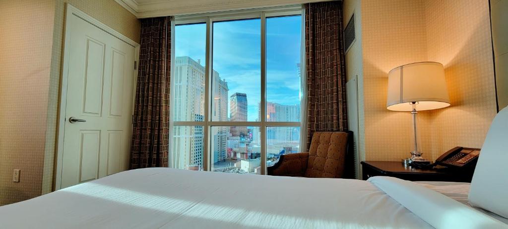 A bed or beds in a room at Awesome The Signature MGM condo with Strip view. No resort fee!