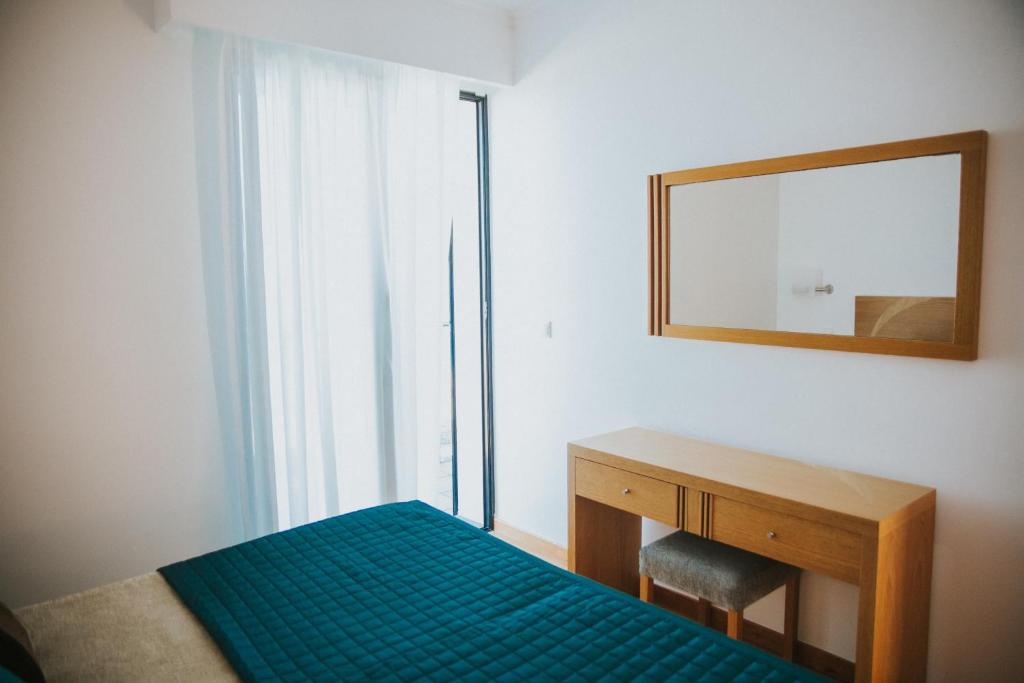 Postel nebo postele na pokoji v ubytování Casa da Capelinha