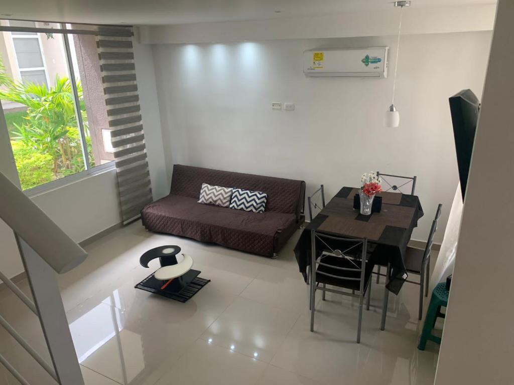 a living room with a couch and a table at Via Ricaurte-Girardot-Colombia, Casa de dos pisos en Condominio in Girardot