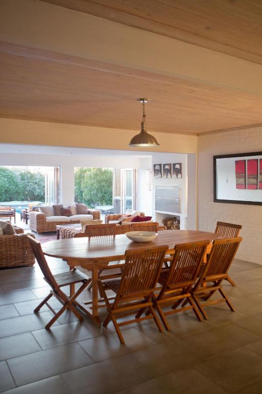 a living room with a wooden table and chairs at Villa Del Mar in Clareport