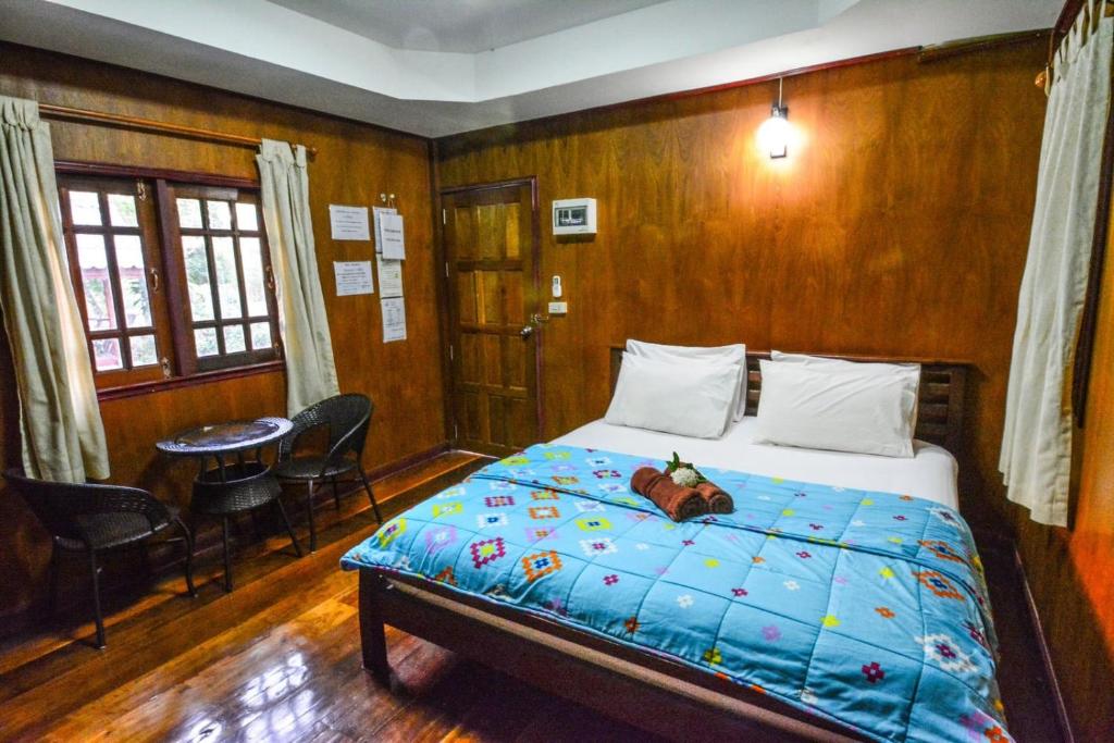 a bedroom with a bed with a teddy bear on it at Pruksa Resort Prachin Buri in Prachin Buri