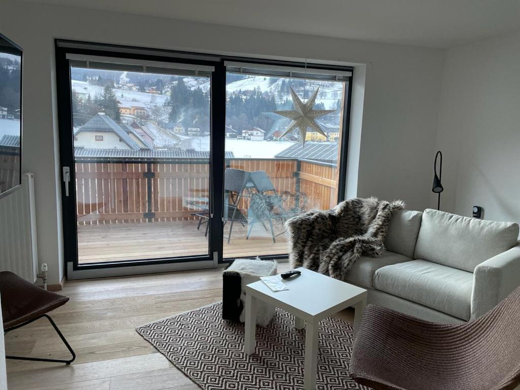 a living room with a couch and a table at Naturpark Appartment in Ratting