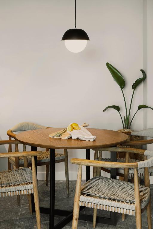 a wooden table with chairs and a potted plant at Aposperia Memorable Living in Kyra Panagia