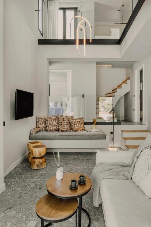a living room with a couch and a table at Aposperia Memorable Living in Kyra Panagia