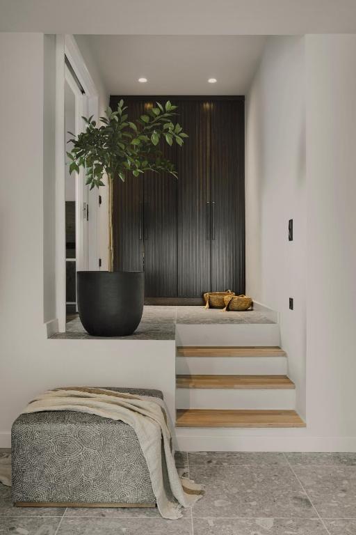 a room with stairs with a potted plant at Aposperia Memorable Living in Kyra Panagia