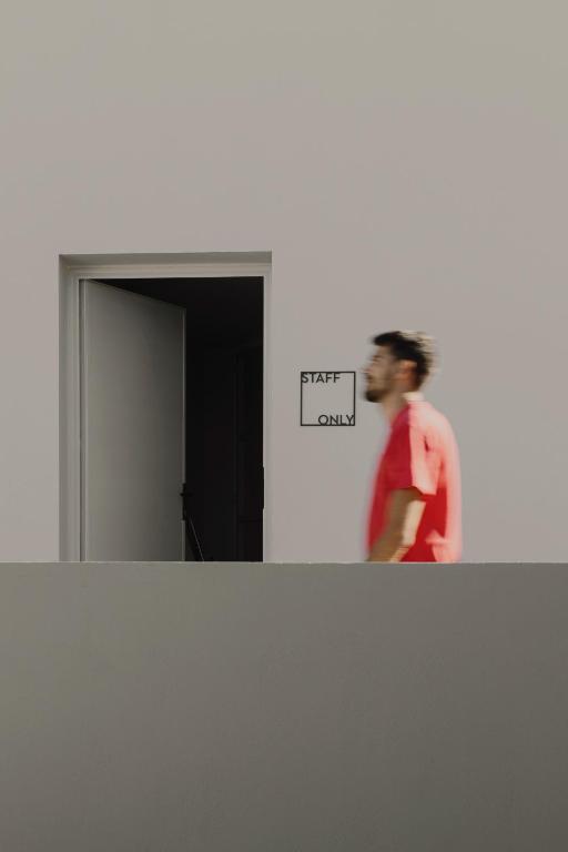 a man standing in front of a mirror in a room at Aposperia Memorable Living in Kyra Panagia