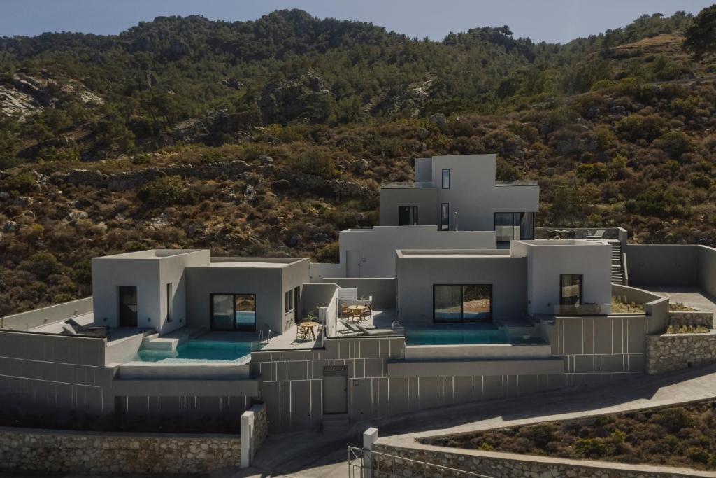an aerial view of a white house on a hill at Aposperia Memorable Living in Kyra Panagia