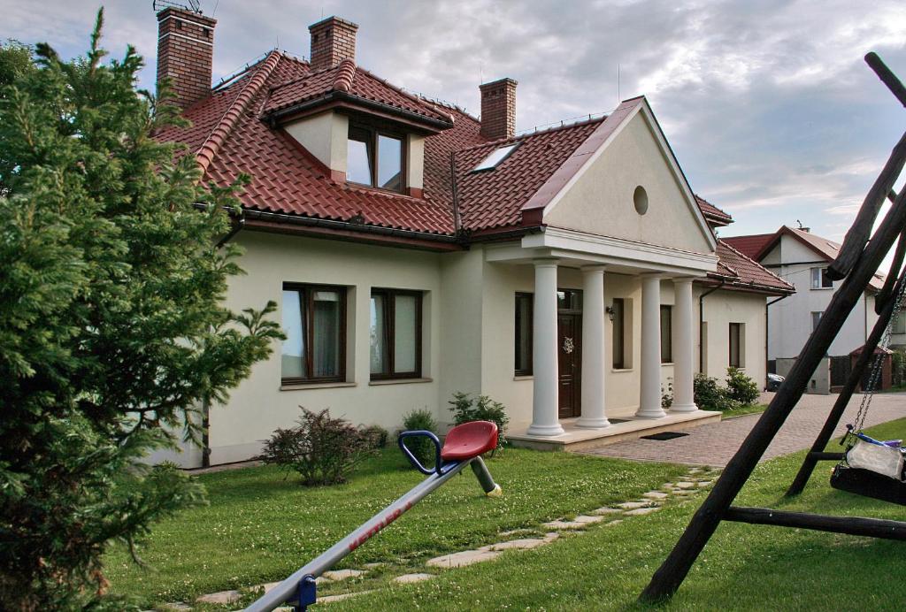 a house with a golf club in front of it at Villa Sofia in Kraków