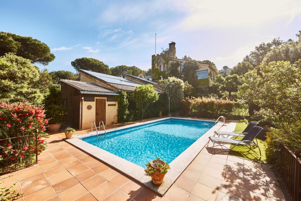 a swimming pool in the backyard of a house at Main Villa: La Bruguera de Púbol in Púbol