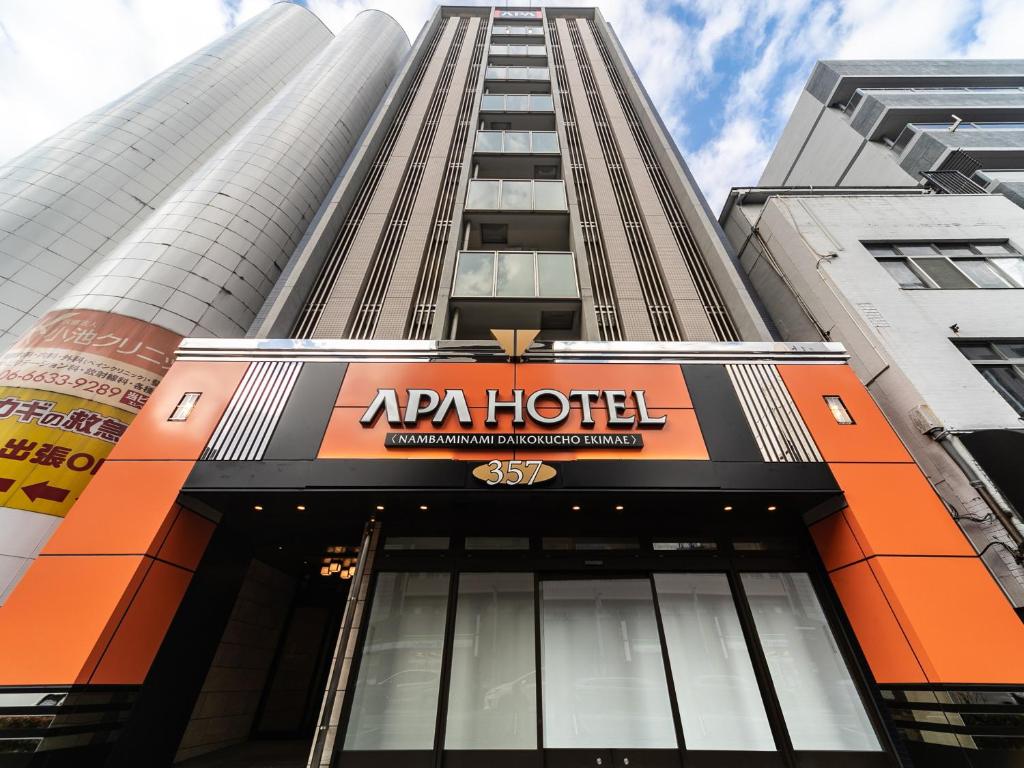 a building with an apri hotel sign in front of it at APA Hotel Namba Minami Daikokucho Ekimae in Osaka
