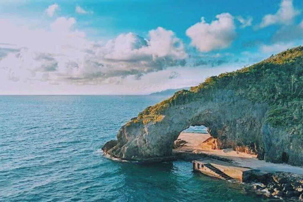 a beach with an arch in the middle of the ocean at New Paradise Ocean View Apartment (DOT accredited) in Boracay