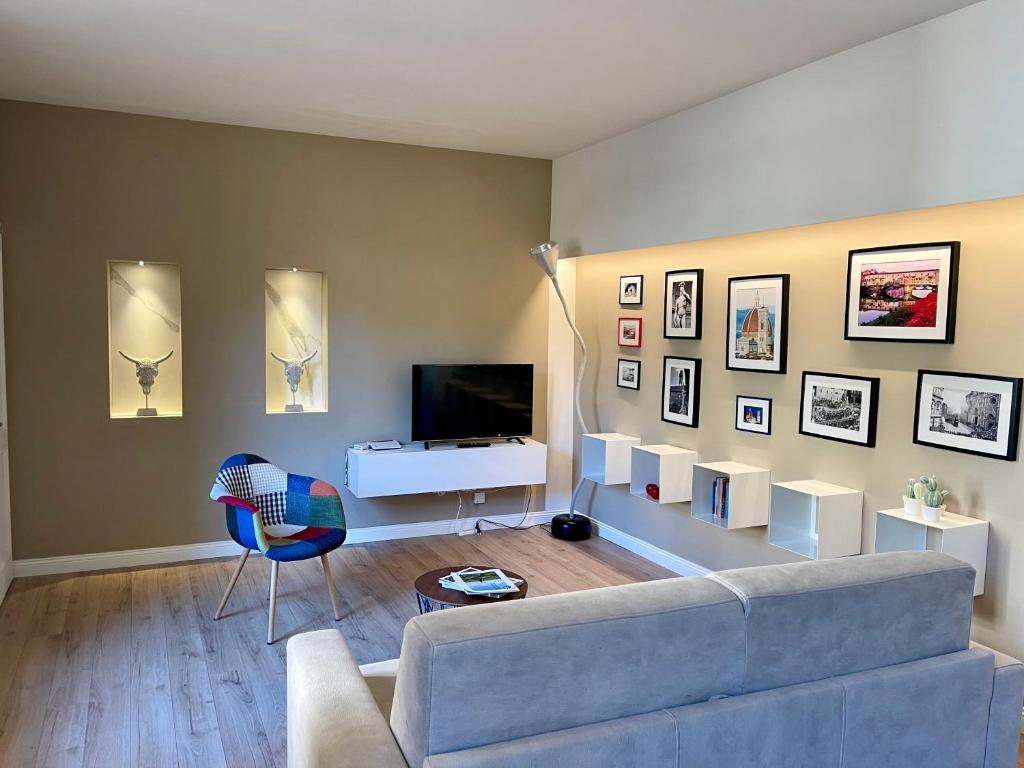 a living room with a couch and a tv at Luxury apartment in city center in Florence