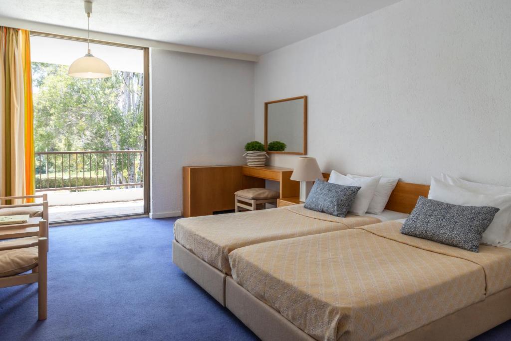 Postel nebo postele na pokoji v ubytování Amalia Hotel Olympia