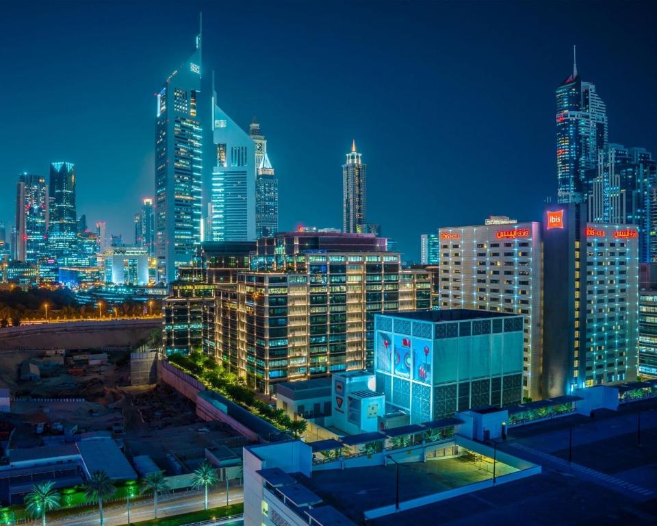 a city skyline at night with tall buildings at Ibis One Central - World Trade Centre Dubai in Dubai