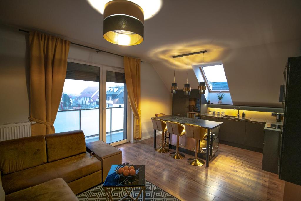 a living room with a couch and a table at Apartament w Cieplicach 6 Gold in Jelenia Góra