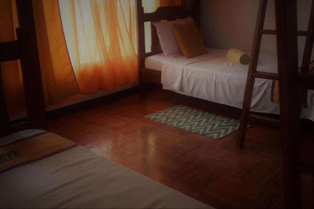 Postel nebo postele na pokoji v ubytování Lajuela BnB & Hostel