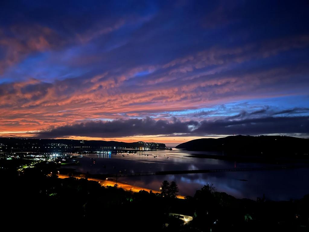 a view of a body of water at night at Paradise Found in Knysna