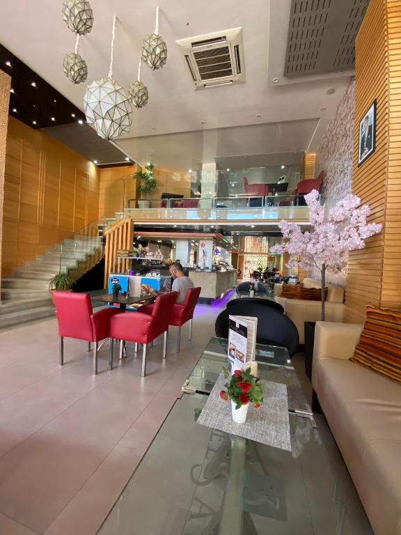 a lobby of a hotel with a person sitting at a table at Hotel VELSATIS in Beni Mellal